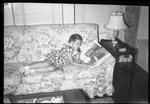 Girl Reading on Couch by Fred A. Blocker