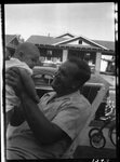 Man Holding Baby by Fred A. Blocker