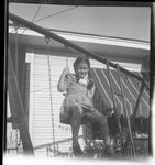 Girl Sitting on High Swing by Fred A. Blocker