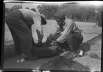 Men Bent Over Tire by Fred A. Blocker