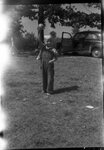Boy Holding Up Ball by Fred A. Blocker