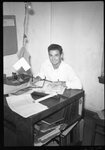 Man Seated Behind Desk by Fred A. Blocker