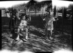 Children Playing on Swing Set by Fred A. Blocker