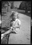Girl Sitting on Sidewalk by Fred A. Blocker