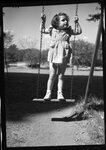 Girl Standing on Swing by Fred A. Blocker