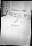 Baby Laughing on Bed by Fred A. Blocker