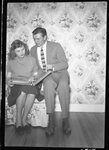 Couple Looking at Photo Album by Fred A. Blocker