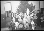 Children with Santa in front of Christmas Tree by Fred A. Blocker