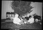 Children with Toys Under Christmas Tree by Fred A. Blocker