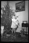 Girl in front of Christmas Tree by Fred A. Blocker