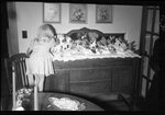 Girl Playing with Christmas Display by Fred A. Blocker