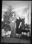 Couple in front of Christmas Tree by Fred A. Blocker