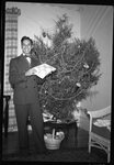 Man in front of Christmas Tree by Fred A. Blocker