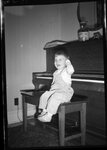 Boy Sitting in front of Piano by Fred A. Blocker