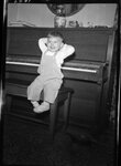 Boy Sitting in front of Piano by Fred A. Blocker