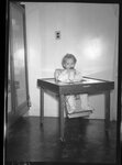 Girl Sitting in High Chair by Fred A. Blocker
