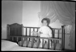 Girl Standing in Crib by Fred A. Blocker