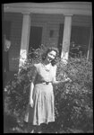 Woman Posing in front of House by Fred A. Blocker