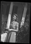 Woman Posing in front of House by Fred A. Blocker
