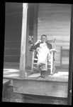 Man Seated on Porch by Fred A. Blocker