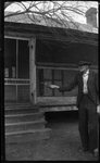 Man with Bird in front of House by Fred A. Blocker
