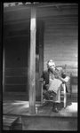Man Sitting on Porch by Fred A. Blocker