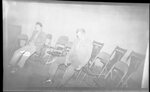 Men Sitting in Folding Chairs by Fred A. Blocker