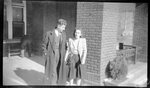 Couple Outside Campus Building by Fred A. Blocker