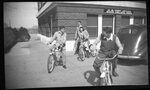 Students Riding Bikes by Post Office by Fred A. Blocker