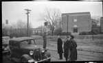 Man Standing on Fender Talking to Group by Fred A. Blocker