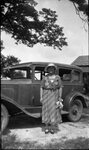 Woman Posing with Parked Car by Fred A. Blocker