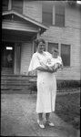 Woman and Baby in front of House by Fred A. Blocker