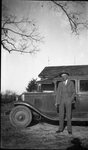 Man Posing with Parked Car by Fred A. Blocker