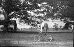 Boy Doing Tricks on Bicycle by Fred A. Blocker