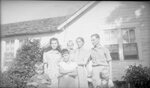 Family in front of House by Fred A. Blocker