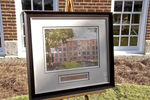 Photograph of building, framed with name plate